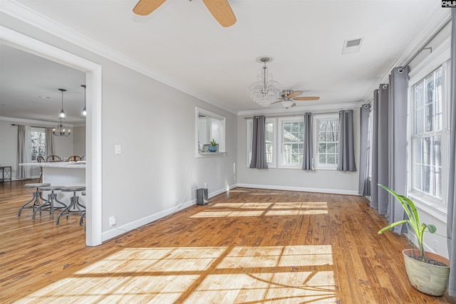 sunroom with ceiling fan with notable chandelier and plenty of natural light