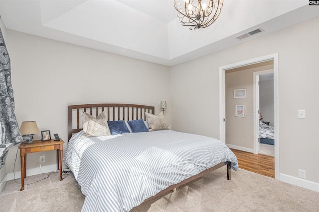 carpeted bedroom with a notable chandelier