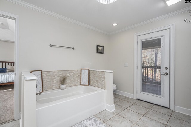 bathroom featuring a bathing tub, toilet, crown molding, and tile patterned floors