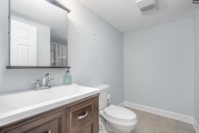 bathroom featuring tile patterned floors, vanity, and toilet