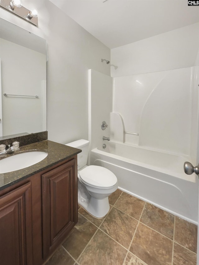 full bathroom featuring vanity, toilet, and washtub / shower combination