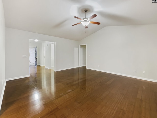 empty room featuring ceiling fan, lofted ceiling, and dark wood-type flooring