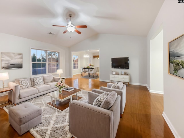 living room with ceiling fan, wood-type flooring, and lofted ceiling