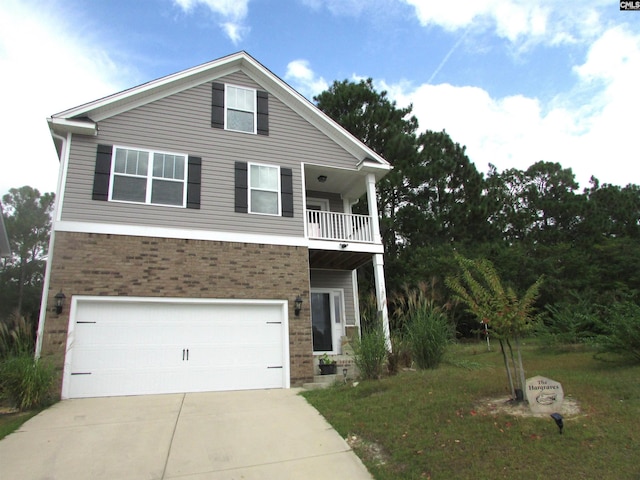 view of front of home with a balcony, a front yard, and a garage