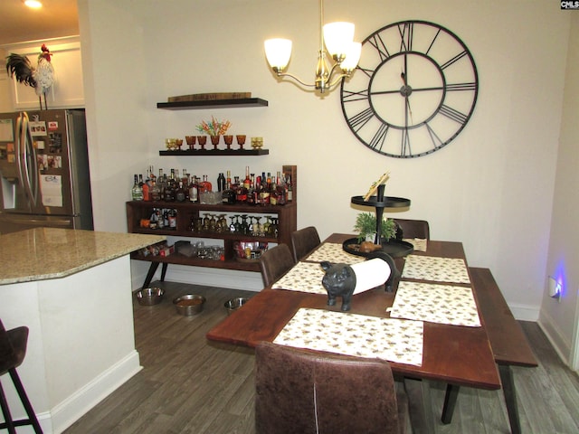 dining room featuring dark hardwood / wood-style flooring and an inviting chandelier