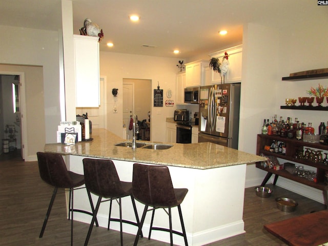 kitchen with white cabinets, sink, dark hardwood / wood-style floors, kitchen peninsula, and stainless steel appliances