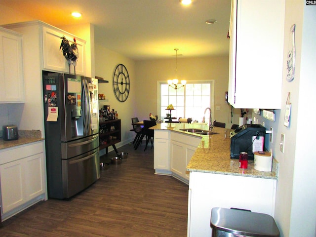 kitchen with dark wood-type flooring, sink, pendant lighting, white cabinets, and stainless steel fridge with ice dispenser