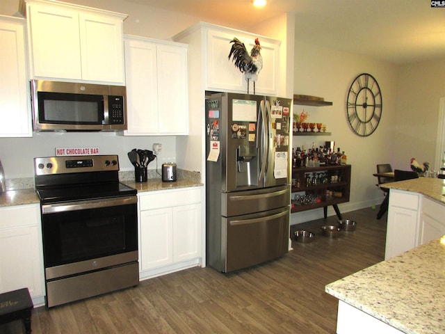 kitchen with white cabinets, dark wood-type flooring, and appliances with stainless steel finishes