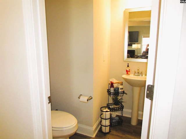 bathroom with sink, hardwood / wood-style floors, and toilet