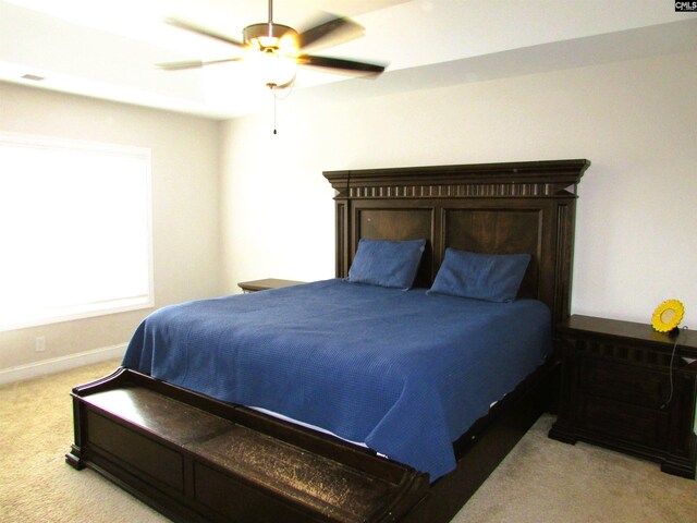 bedroom featuring ceiling fan and light carpet