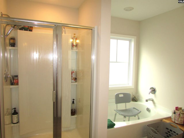 bathroom featuring separate shower and tub