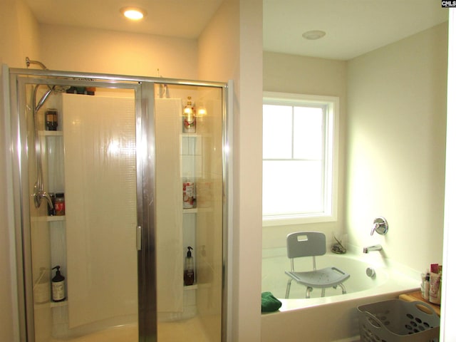 bathroom featuring separate shower and tub