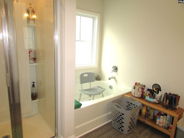 bathroom featuring hardwood / wood-style floors and separate shower and tub