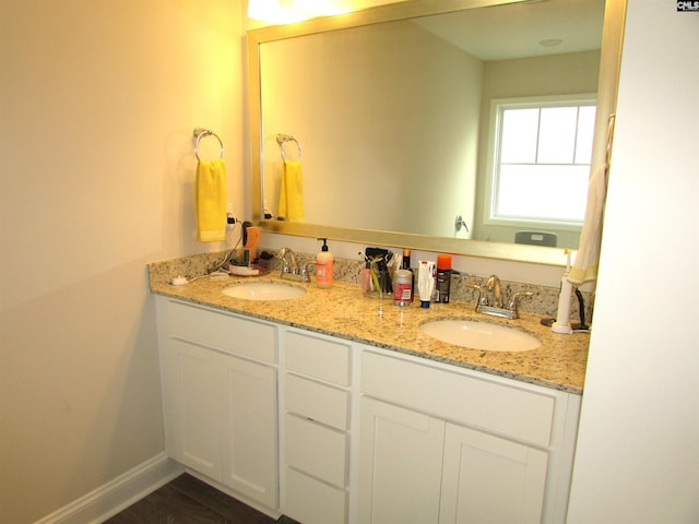 bathroom with vanity and hardwood / wood-style flooring