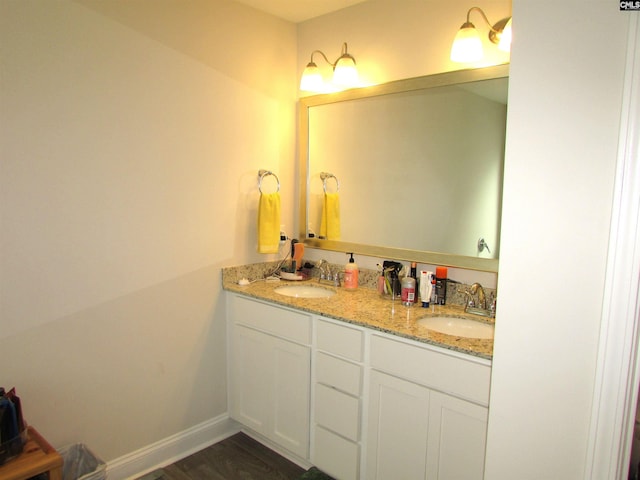 bathroom with hardwood / wood-style floors and vanity