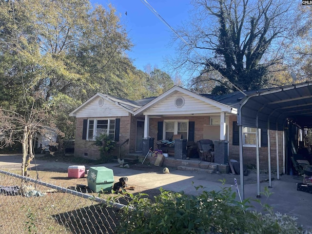 single story home with covered porch and a carport