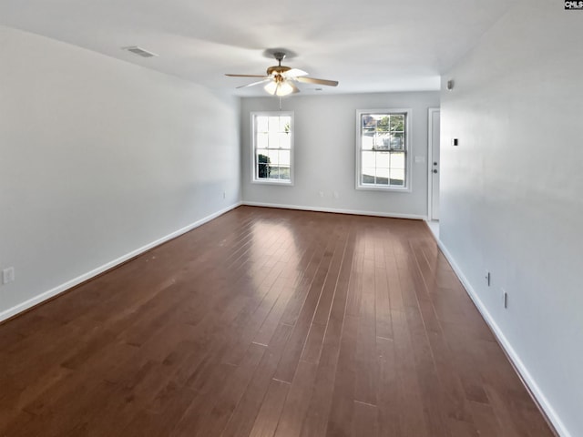 empty room with ceiling fan and dark hardwood / wood-style floors