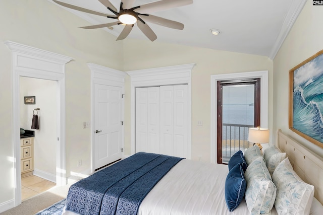 carpeted bedroom with ceiling fan, a closet, and vaulted ceiling