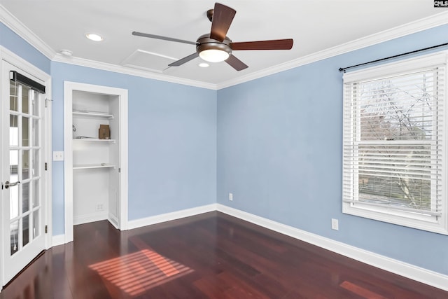 spare room featuring ceiling fan, dark wood-type flooring, and ornamental molding