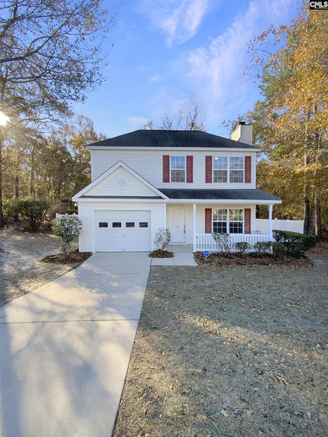 view of front facade with a front lawn, a porch, and a garage