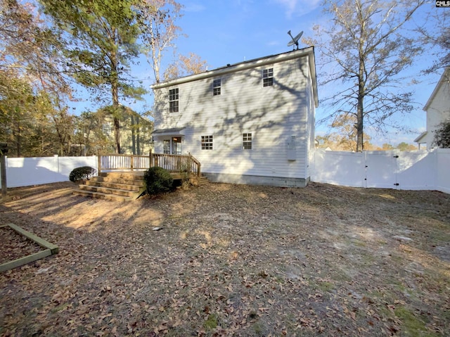 back of house featuring a deck