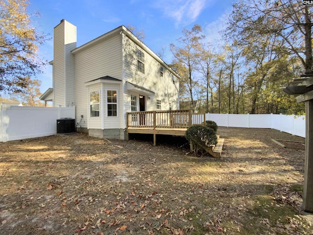 rear view of house featuring a wooden deck