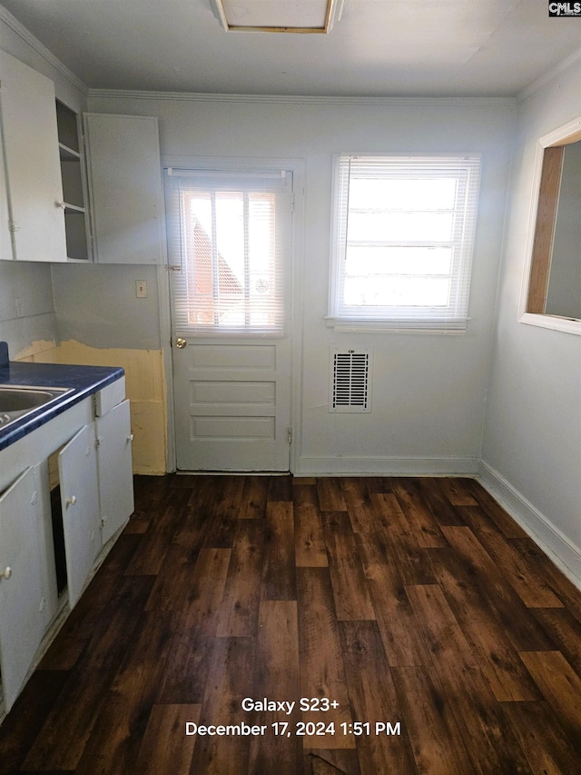 kitchen featuring dark hardwood / wood-style floors, white cabinetry, and sink