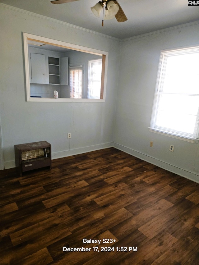 spare room featuring ceiling fan, dark wood-type flooring, and ornamental molding