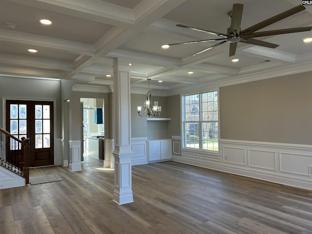 entrance foyer with ornate columns, ornamental molding, coffered ceiling, dark wood-type flooring, and beam ceiling