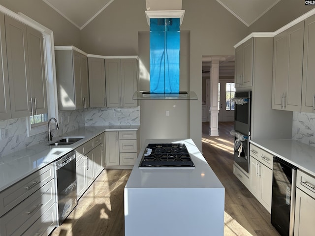 kitchen featuring black appliances, light wood-type flooring, sink, and vaulted ceiling