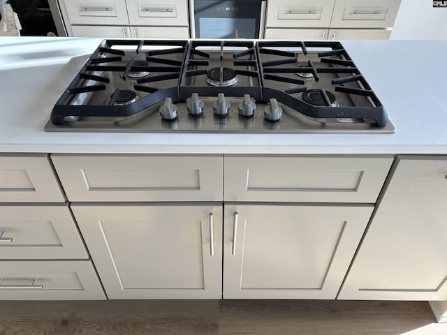 interior details featuring white cabinetry and gas cooktop