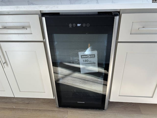 details with white cabinetry and beverage cooler