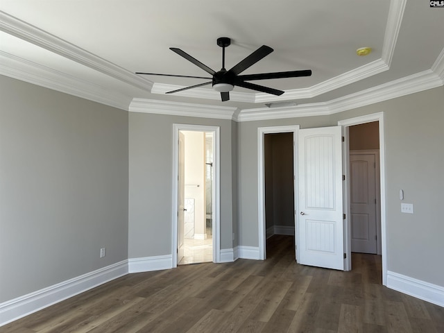 unfurnished bedroom with ensuite bathroom, dark hardwood / wood-style flooring, ceiling fan, and crown molding