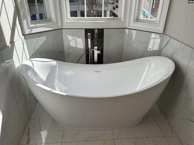 bathroom featuring tile walls and a bathing tub