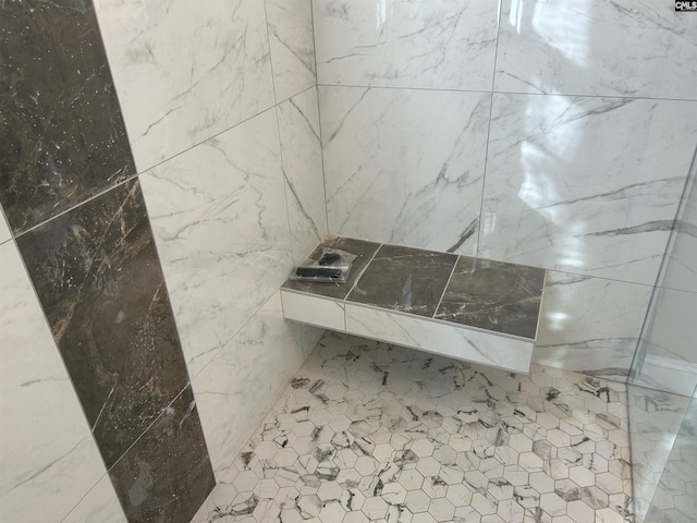 bathroom featuring walk in shower and tile walls