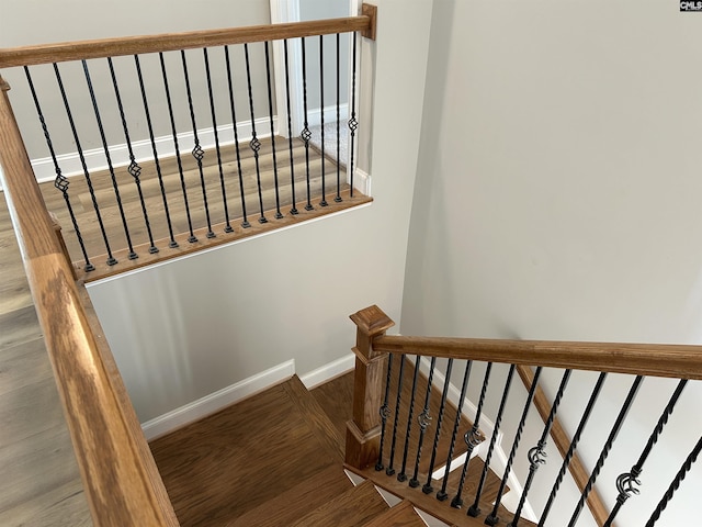 stairway featuring wood-type flooring