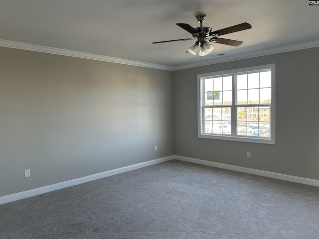 spare room featuring carpet floors, ceiling fan, and crown molding