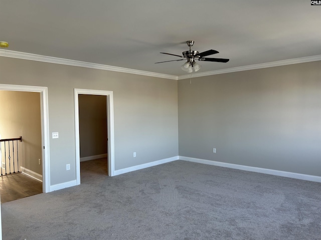 carpeted spare room featuring ceiling fan and ornamental molding