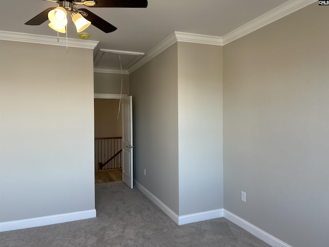 carpeted empty room featuring ceiling fan and ornamental molding