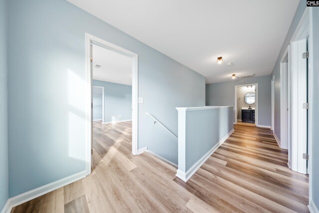 corridor with light wood-type flooring