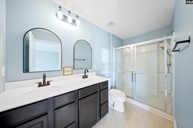 bathroom featuring vanity, toilet, and an enclosed shower