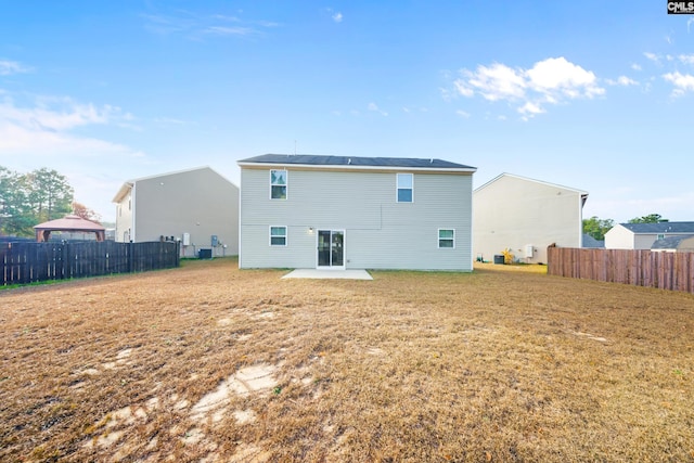 back of property featuring a patio area and a yard