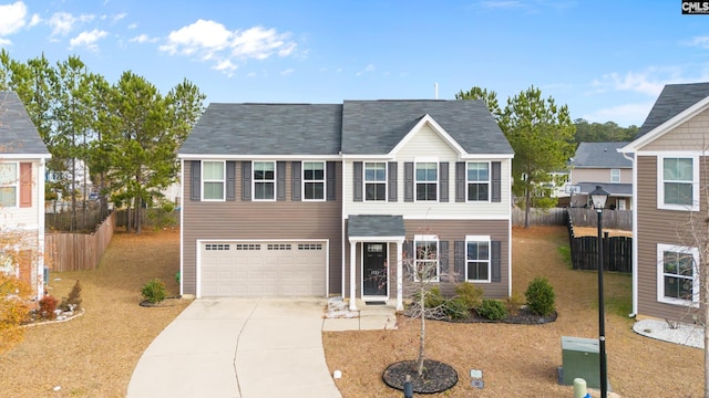 view of front of property with a garage and a front lawn