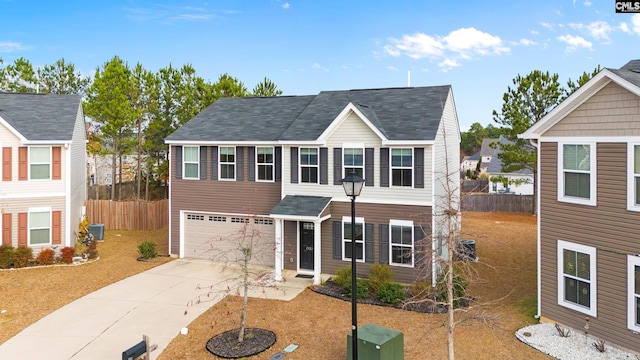 view of front facade with a garage and central AC unit