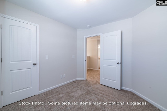 unfurnished bedroom featuring light carpet