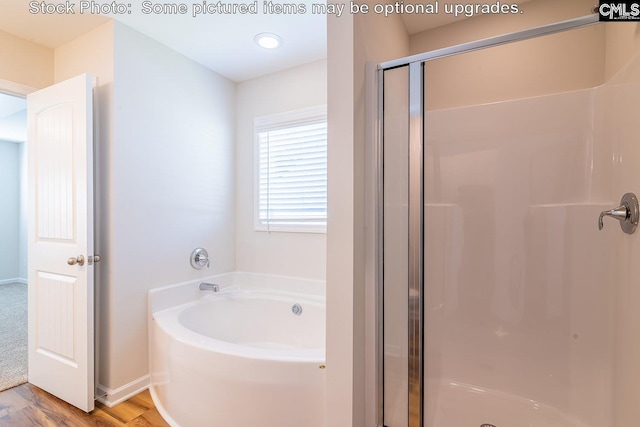 bathroom with hardwood / wood-style floors and plus walk in shower