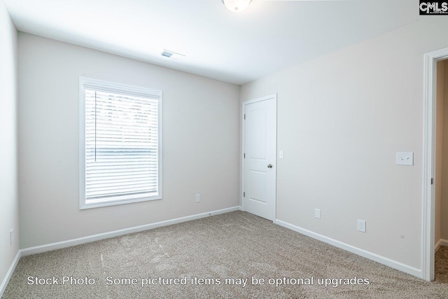 empty room featuring light colored carpet