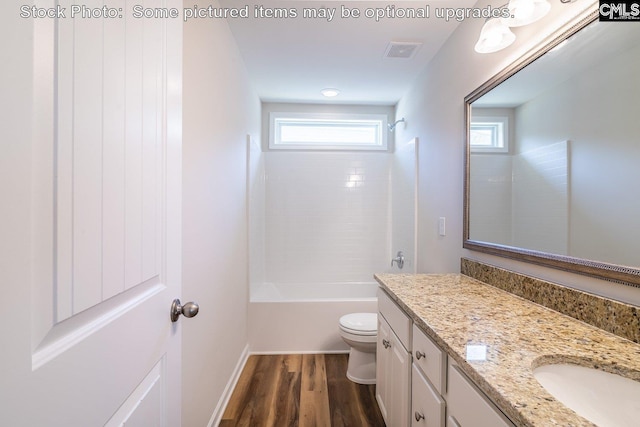 full bathroom with washtub / shower combination, wood-type flooring, vanity, and toilet