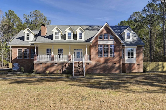 new england style home featuring covered porch and a front lawn