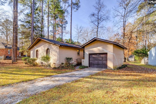 ranch-style house with a garage and a front yard